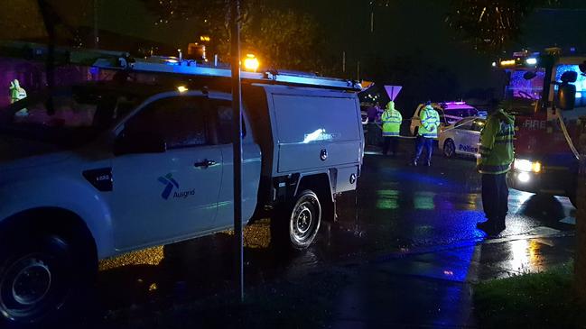 Ausgrid worked to shut off power in the street so emergency responders could reach the man. Picture: Steve Tyson