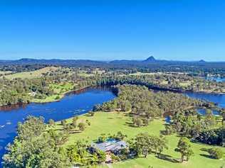 Majestic home perched on natural Coast lake hits market