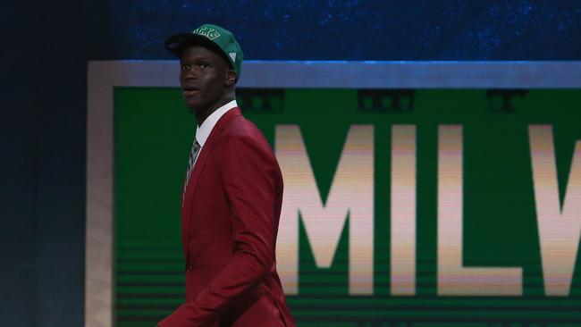 Thon Maker walks off stage after being drafted 10th overall by the Milwaukee Bucks.