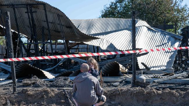 03-03-2025 Matthew McCulloch with daughter Chelsea inspect the remains of their house after in burnt down in Winchelsea Picture: Brad Fleet