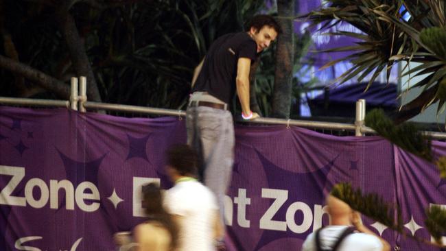 A man looks over the Schoolies fence.