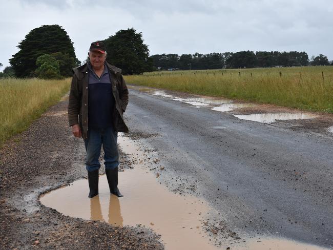 Kevin Bourke shows how deep pot holes are on the Woolsthorpe/Heywood Road at Bessiebelle back in 2017.