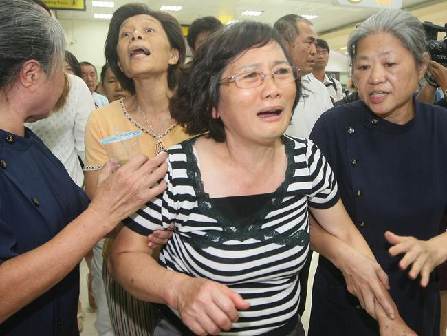 A relative of a passenger on the Taiwan domestic TransAsia Airways flight GE222 reacts at the flight's departure airport in Kaohsiung, southern Taiwan.
