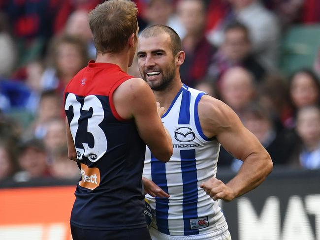 Ben Cunnington of the Kangaroos (right) punches Bernie Vince of the Demons in the stomach during the Round 9 AFL match between the Melbourne Demons and the North Melbourne Kangaroos at the MCG in Melbourne, Sunday, May 21, 2017. (AAP Image/Julian Smith) NO ARCHIVING, EDITORIAL USE ONLY