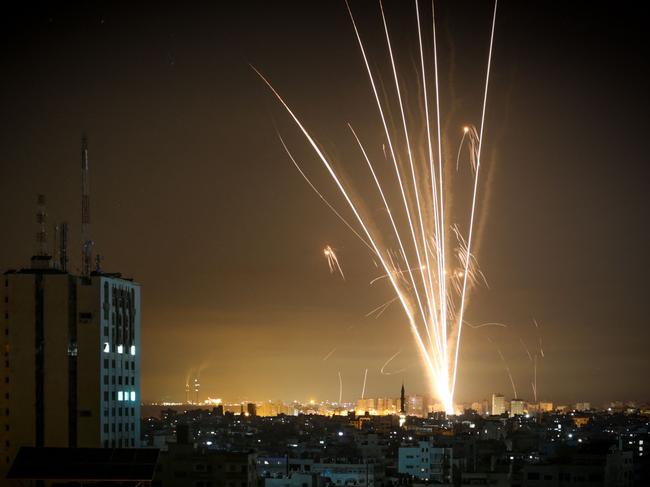 Rockets are seen in the night sky fired towards Israel from Beit Lahia in the northern Gaza Strip. Picture: Anas Baba / AFP