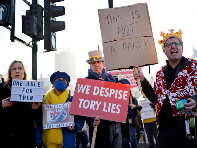 Protesters outside British Parliament as Boris Johnson offered an apology inside. Picture: AFP