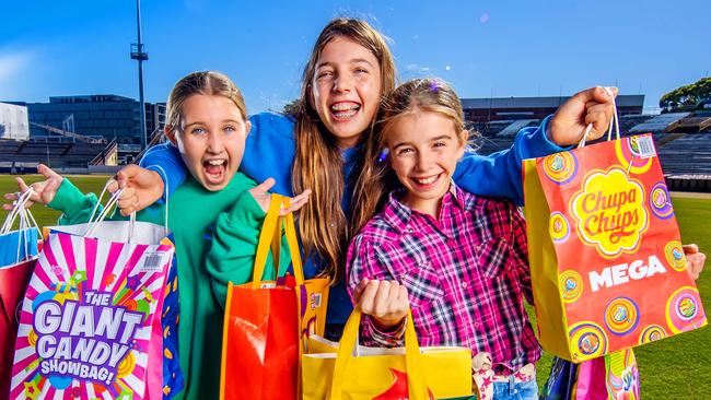 EKKA 2024 - Peggy Mackenzie, 10, Charlotte Pentland, 11 and Esther McKeering, 11 get a preview of this years showbags.Picture: Nigel Hallett