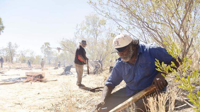 Ross Purpis removes hair from a kangaroo tail during the 90th anniversary commemoration of the Coniston Massacre at Yurrkuru on Friday, August 24, 2018. Picture: Keri Megelus