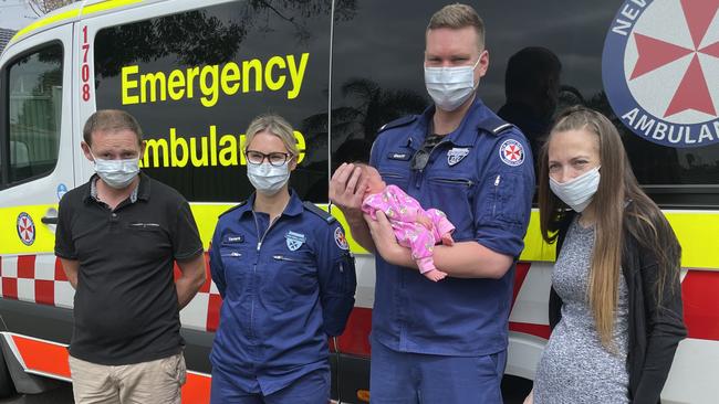 Newborn Rosie-May with the paramedics who helped deliver her and parents Elisha Hands and Brendan Burnham