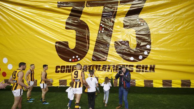 Shaun Burgoyne of the Hawks runs out with his family in his record-setting match against North Melbourne. Picture: Getty Images