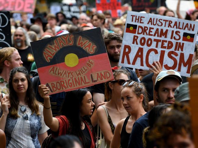 Protesters are seen during the Invasion Day rally in Melbourne, Sunday, January 26, 2020. (AAP Image/James Ross) NO ARCHIVING