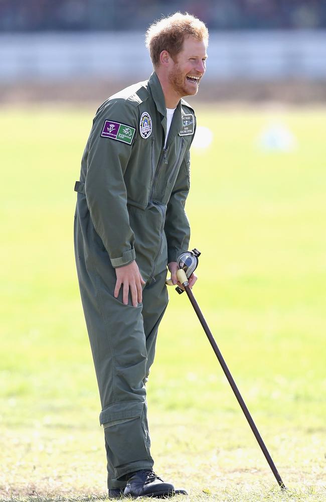 Prince Harry holds on to year old RAF veteranTom Neil’s walking stick as he watches the Spitfires take off on the airfield at Goodwood Aerodrome during a Battle of Britain Flypast at Goodwood in Chichester, England. Picture: Getty