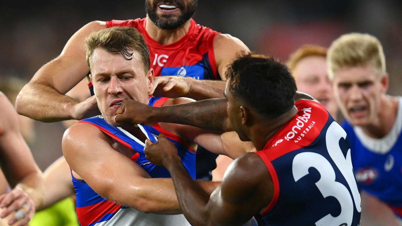 MELBOURNE, AUSTRALIA - MARCH 18: Jackson Macrae of the Bulldogs remonstrates with Kysaiah Pickett of the Demons after a bump on Bailey Smith of the Bulldogs during the round one AFL match between Melbourne Demons and Western Bulldogs at Melbourne Cricket Ground, on March 18, 2023, in Melbourne, Australia. (Photo by Quinn Rooney/Getty Images)