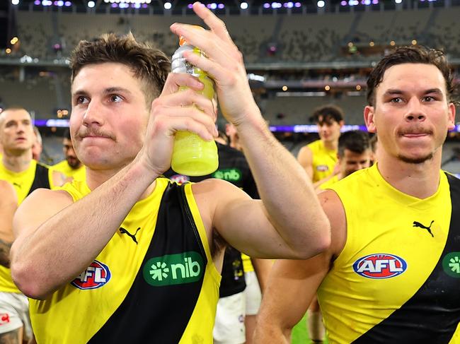 PERTH, AUSTRALIA - JUNE 10: Liam Baker and Daniel Rioli of the Tigers lead the team from the field after winning the round 13 AFL match between Fremantle Dockers and Richmond Tigers at Optus Stadium, on June 10, 2023, in Perth, Australia. (Photo by Paul Kane/Getty Images)