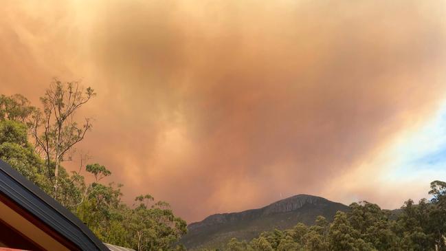 A dramatic smoke plume from the Gell River fire over kunanyi/Mt Wellington, taken from South Hobart. Picture: PETER GRANT