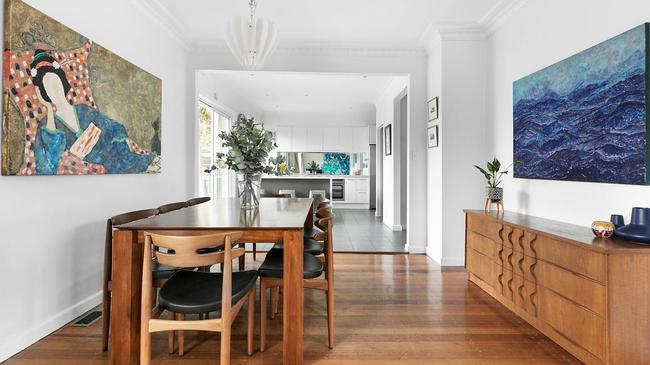 The open plan living and dining areas includes timber floorboards.