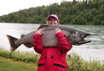 Up to scale .. an angler hugs an Alaskan king salmon and thinks of dinner