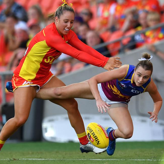 Jacqui Yorston (left) of the Suns tackles Gabby Collingwood (right) of the Lions during the Round 3 AFLW match between the Gold Coast Suns and Brisbane Lions at Metricon Stadium on the Gold Coast, Saturday, February 22, 2020 (AAP Image/Darren England)