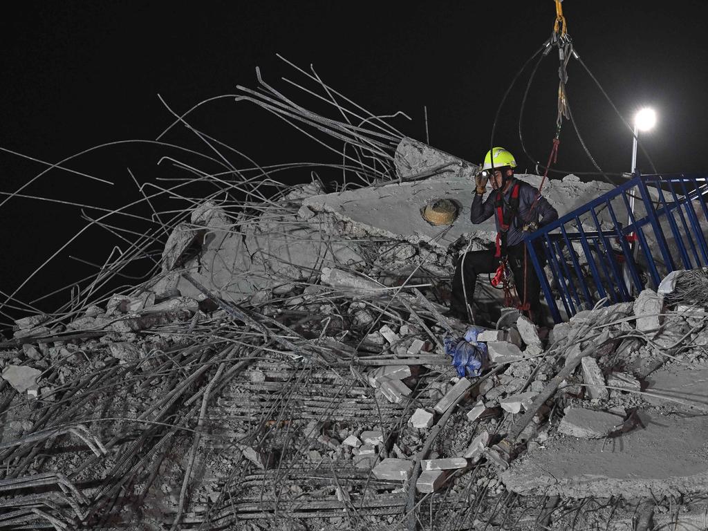 Rescue workers clear rubble on the top at the site of an under-construction building collapse in Bangkok on March 30, 2025, two days after an earthquake struck central Myanmar and Thailand. Picture: Manan Vatsyayana / AFP)