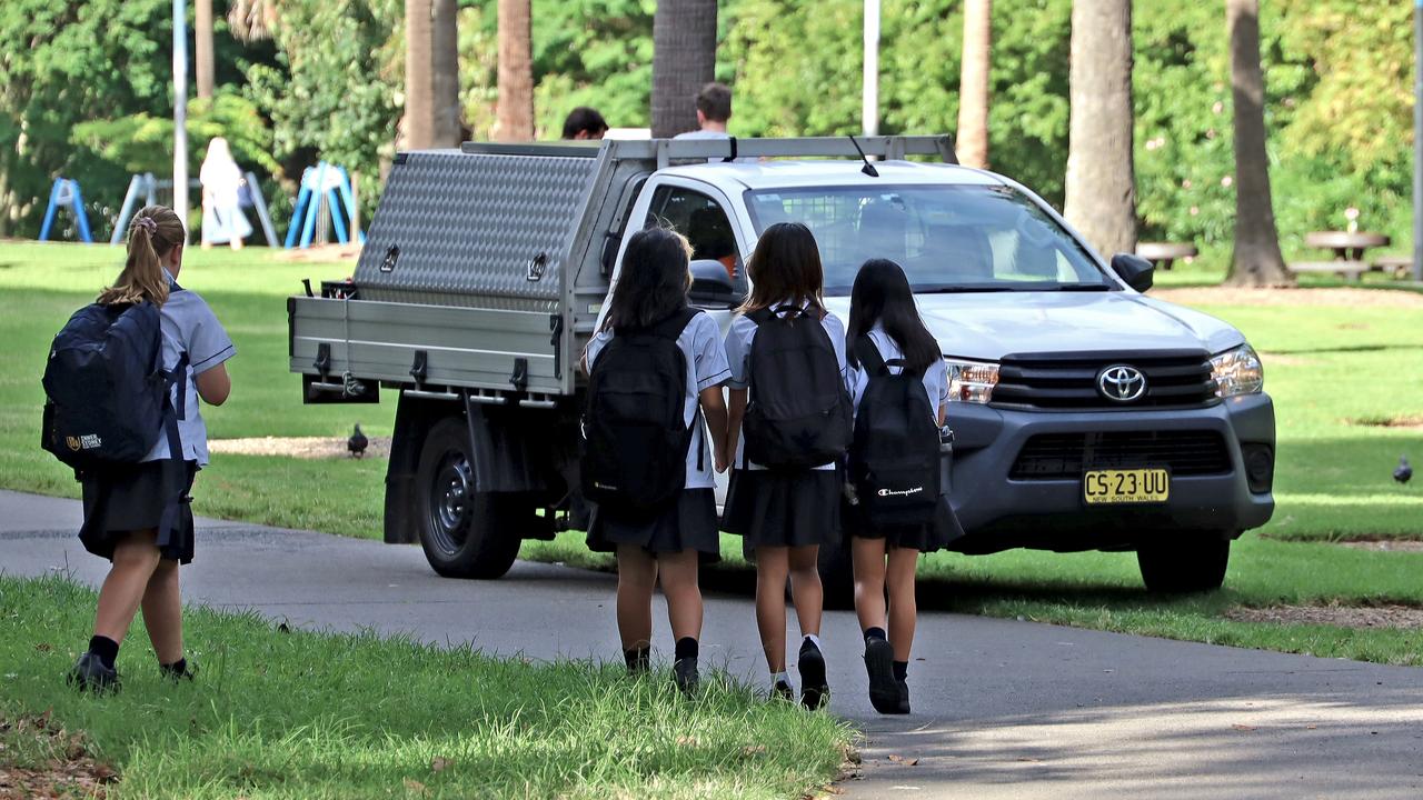 Schoolkids walk by a City of Sydney utility truck at Prince Alfred Park. The park was tested for asbestos contaminated mulch. Picture: NCA NewsWire / Nicholas Eagar