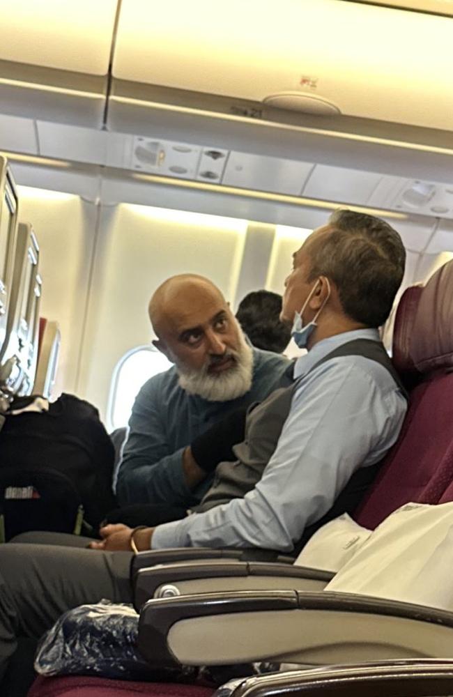 The man, left, speaks to a fellow passenger. Picture: Muhammad Zubair