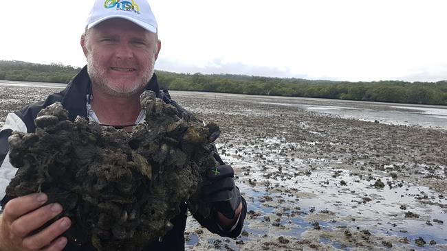 OzFish Unlimited member Robbie Porter with a large block of shellfish near Green Island.