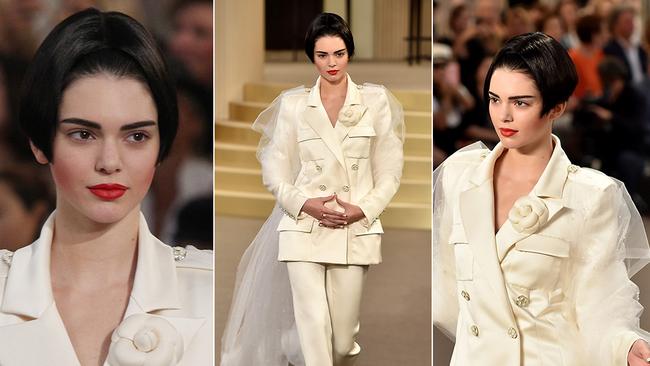 ALMOST unrecognisable in a bobbed wig Kendall Jenner stars in the star-studded Paris runway show, featuring a full house of A-list actors enjoying the casino-theme. Picture: Getty