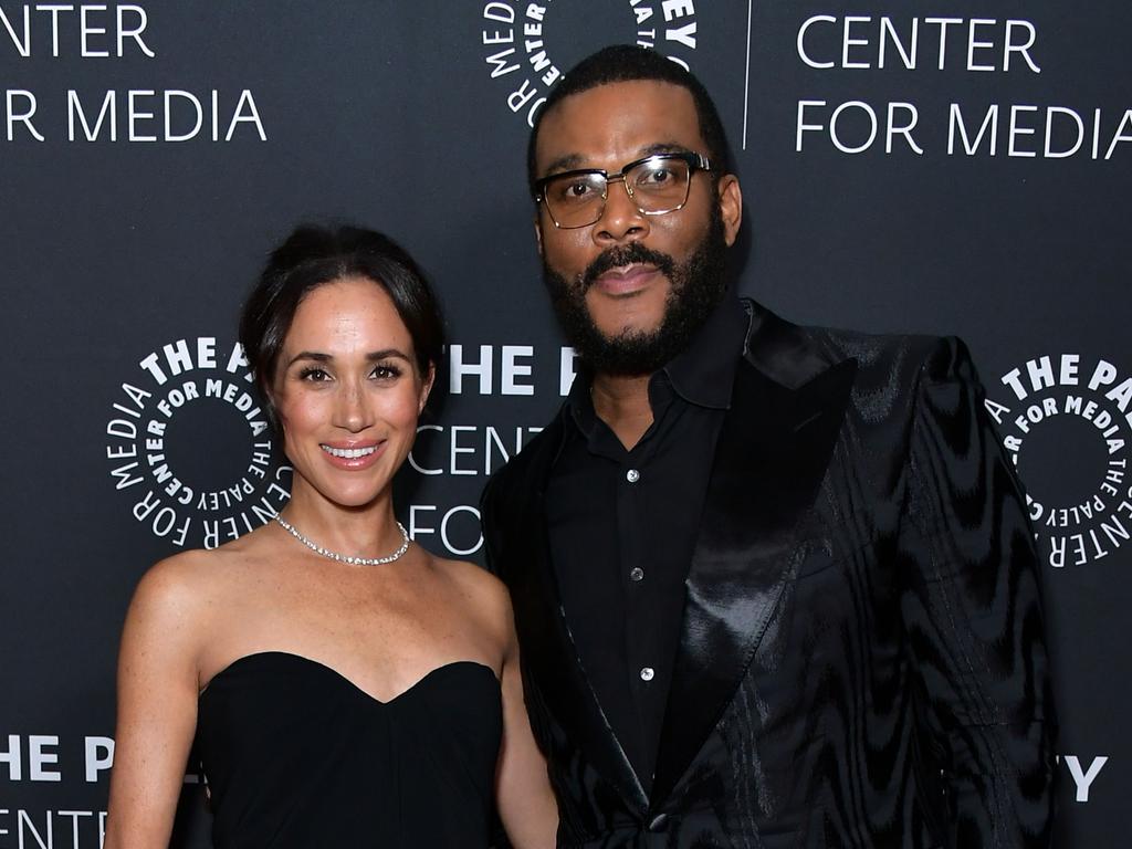 Tyler Perry, with friend Meghan Markle, has slammed insurance companies who cut coverage just prior to the Los Angeles fires. Picture: Getty Images