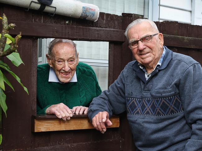 Wal Hopkins (left) and good mate and neighbour Vern Roberts rigged up the PVC pipe to share the Herald Sun each day. Picture: David Caird