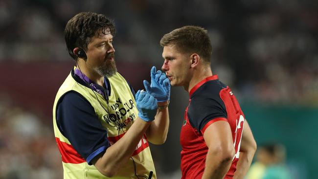 KOBE, JAPAN - SEPTEMBER 26:   Owen Farrell of England receives attention from team doctor Rob Young during the Rugby World Cup 2019 Group C game between England and USA at Kobe Misaki Stadium on September 26, 2019 in Kobe, Hyogo, Japan. (Photo by David Rogers/Getty Images)