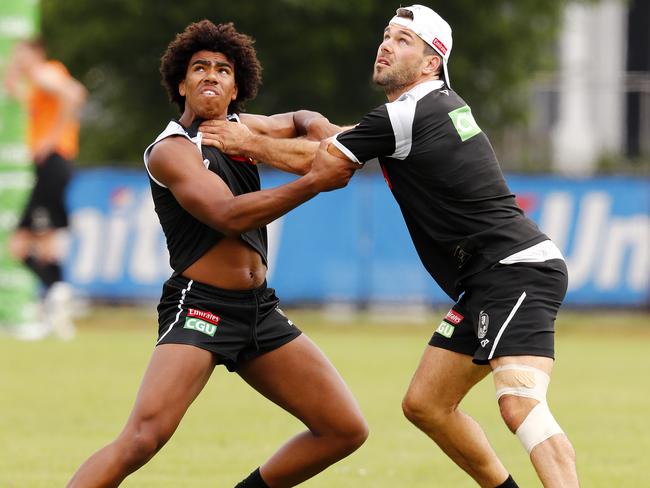 Levi Greenwood (right) battles AFL Academy member Isaac Quaynor at Pies training earlier this month. Pic: Michael Klein