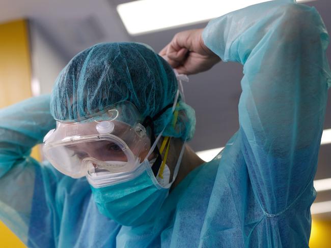 A healthcare worker wearing a protective suit gets ready to attend to a COVID-19 coronavirus patient in Barcelona. Picture: AFP