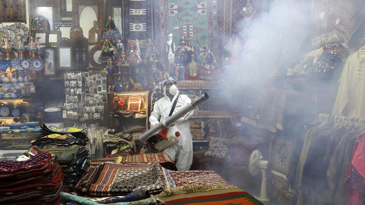 A firefighter disinfects a traditional shopping centre in Tehran, Iran. Picture: AP Photo/Ebrahim Noroozi