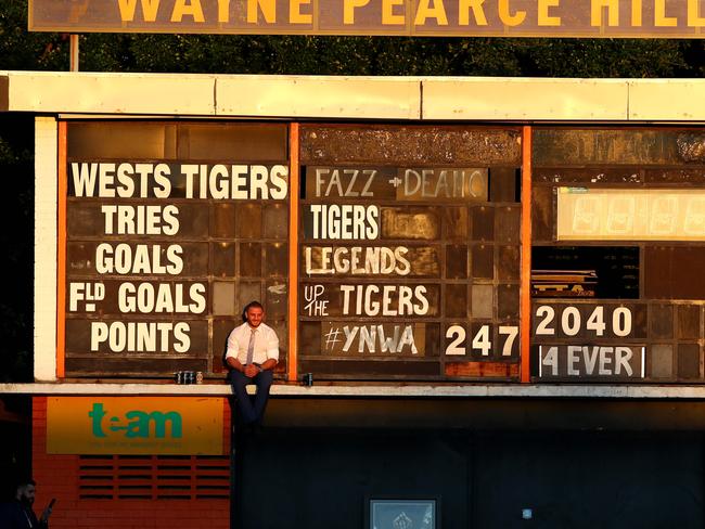 Robbie Farah sits up on the scoreboard drinking beers after the Tigers last game of 2016. Picture: Gregg Porteous