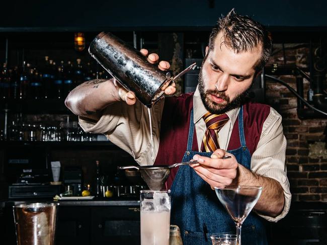 Bartender E.J. Psilas makes a cocktail at Green Russell, a Bonanno Concepts bar in Denver, in February. Occupations such as bartender, butcher, furniture maker and fishmonger are making a resurgence among young middle-class urbanites. PHOTO: RYAN DAVID BROWN FOR THE WALL STREET JOURNAL