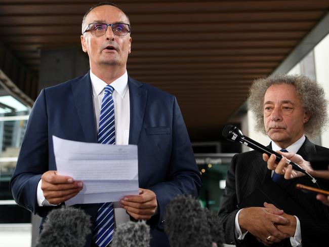 Ardent Leisure CEO John Osborne (left) and Chairman Gary Weiss address the media outside the Magistrates Court in Brisbane but refused to answer questions. (AAP Image/Dan Peled)