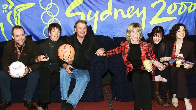 Amorosi with other 2000 Sydney Olympics entertainers, including John Williamson, Julie Anthony, John Farnham, Olivia Newton-John, and Tina Arena.