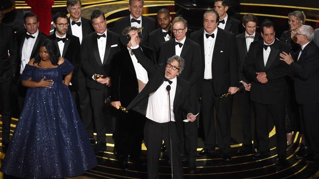 Peter Farrelly, centre, and the cast and crew of Green Book accept the award for best picture at the Oscars. Picture: AP