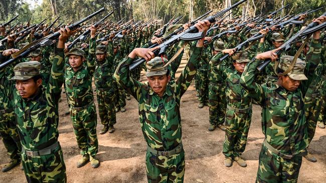 Members of the ethnic rebel group Ta'ang National Liberation Army take part in a training exercise at their base camp in the forest in Myanmar's northern Shan state. Picture: AFP