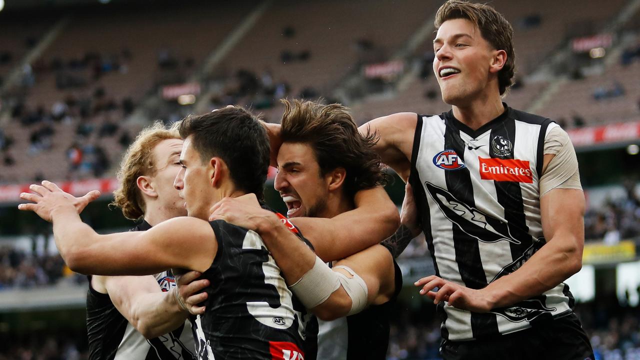 Nick Daicos of the Magpies celebrates a goal with Josh Daicos, Patrick Lipinski and Nathan Murphy of the Magpies during the 2022 AFL Round 17 match between the Collingwood Magpies and the North Melbourne Kangaroos at the Melbourne Cricket Ground on July 09, 2022 in Melbourne, Australia. (Photo by Dylan Burns/AFL Photos via Getty Images)