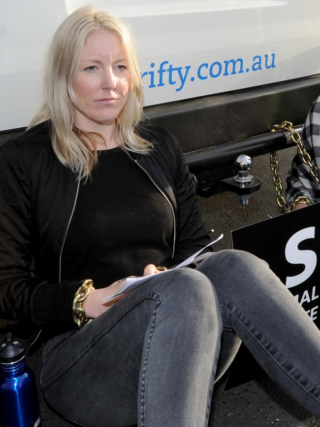 Vegan protesters chained themselves to vans, blocking the intersection. Picture: Andrew Henshaw