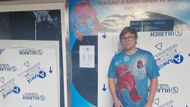 Fantasy Tails owner Zac Kroonenburg with the broken windows in his store.