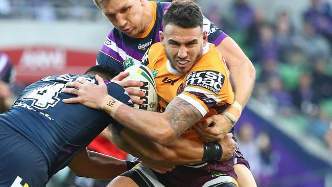 Broncos fullback Darius Boyd is wrapped up by the Storm defence. Picture: Getty Images