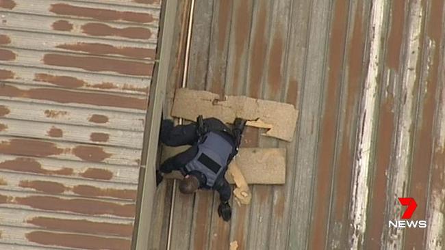 Police search for a burglar on a Melbourne CBD roof. Picture: Channel 7