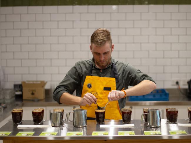 A Campos Coffee employee 'cupping' coffee at its Sydney roastery. Image courtesy of Campos.