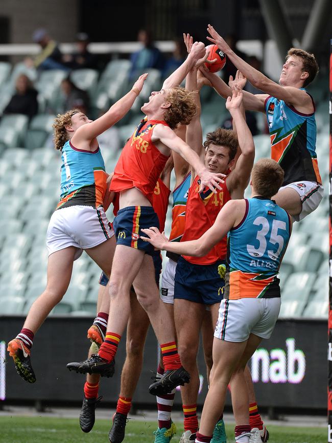 Harrison Petty in the thick of the action for the SA under-18 side. Picture Roger Wyman