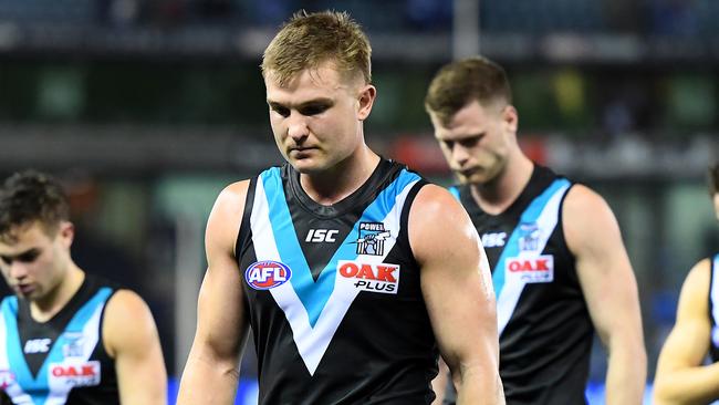 MELBOURNE, AUSTRALIA - AUGUST 17: Ollie Wines and his Power team mates look dejected after losing the round 22 AFL match between the North Melbourne Kangaroos and the Port Adelaide Power at Marvel Stadium on August 17, 2019 in Melbourne, Australia. (Photo by Quinn Rooney/Getty Images)