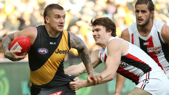 St Kilda’s Blake Acres tries to lay a tackle on Dustin Martin. Picture: Colleen Petch