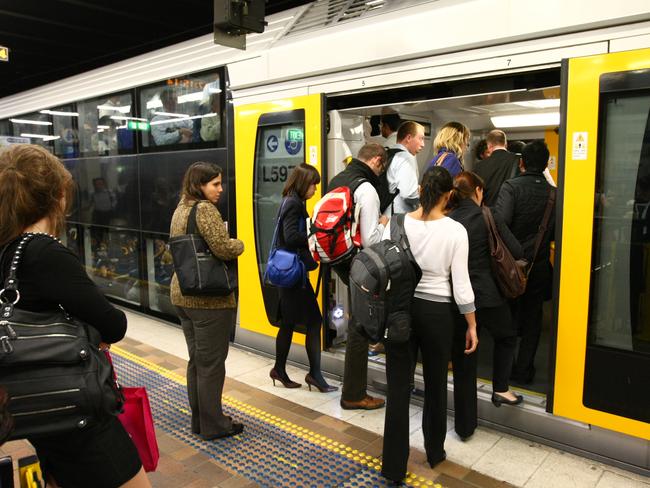 Generic photo of commuters boarding a CityRail train service at platform on Town Hall Station in Sydney.