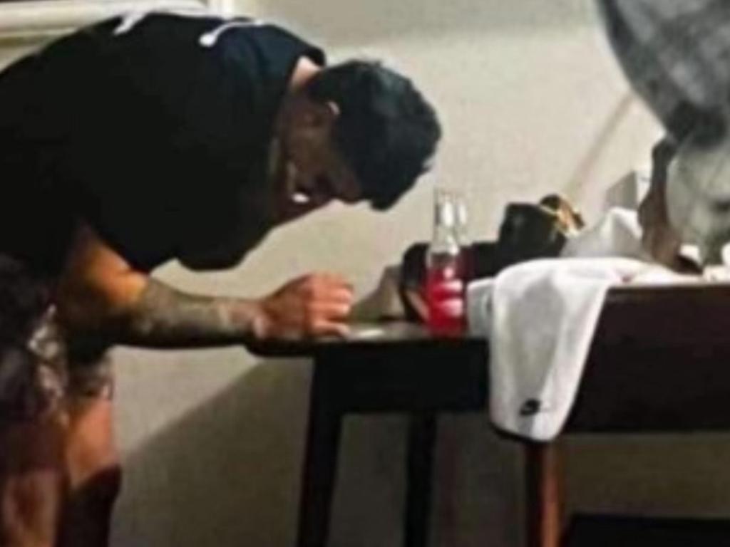 The leaked image that appears to show NRL Star Latrell Mitchell leaning over a table with a white substance on it.